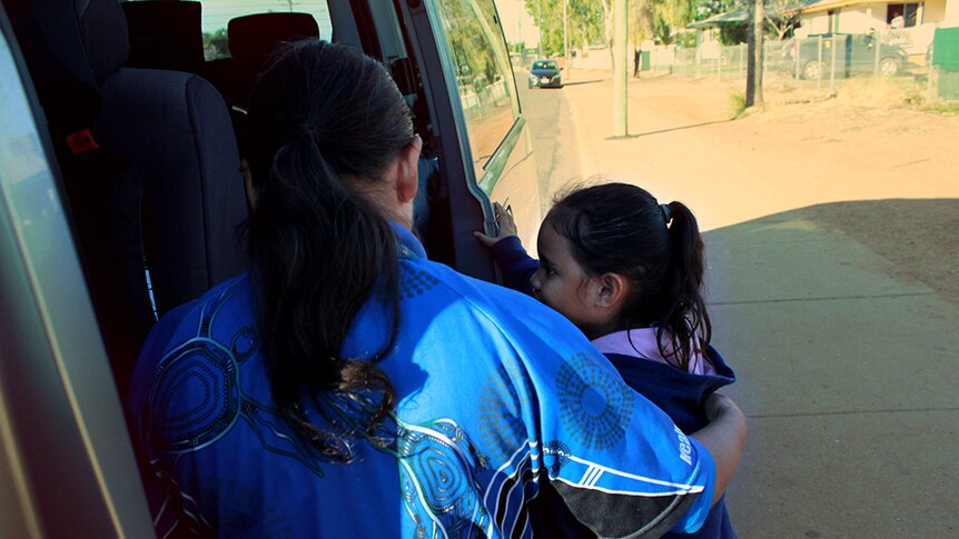 Jenny Craigie helps a Mount Isa student onto the bus.