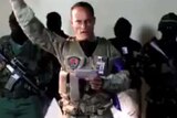 Venezuelan police squad pilot Oscar Perez appears in social media video raising his hand with four masked people behind him