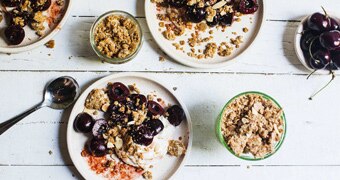 Individual dessert plates with whipped mascarpone, orange soaked cherries and Anzac crumble for a festive and easy dessert.