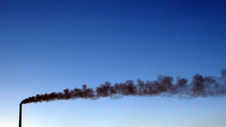 Smoke pours from a chimney