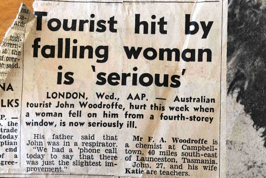 An old black and white newspaper clipping. The headline is "Tourist hit by falling woman is 'serious'"
