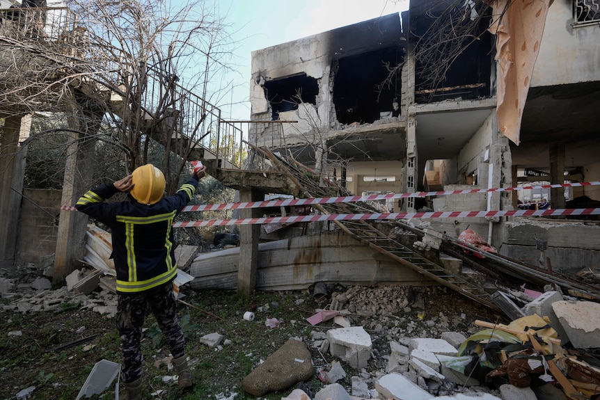 Authorities inspect site of damaged building following an Israeli raid in Jenin.