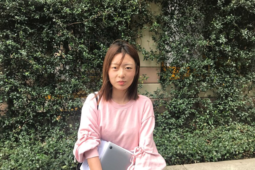 Eva Li in the green quad area of the university.