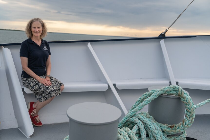 Dr Karen Miller sits for a portrait shot onboard the research boat docked in Darwin harbour.