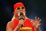 Hulk Hogan in a wrestling ring speaking on a microphone