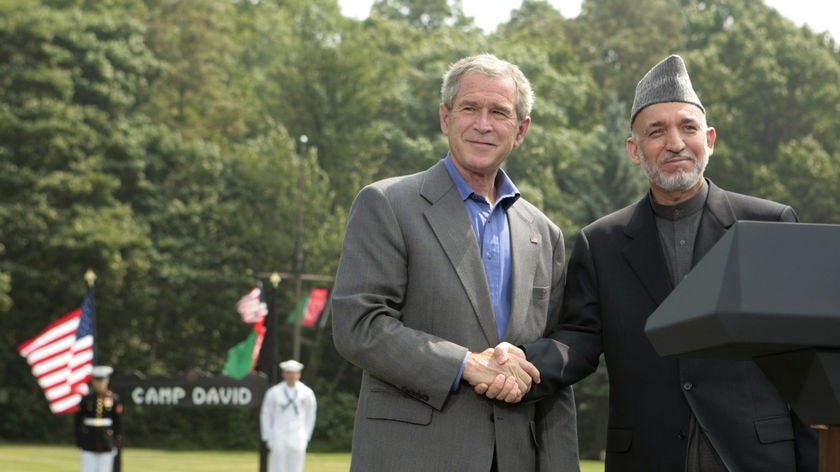 George W Bush and Hamid Karzai shake hands