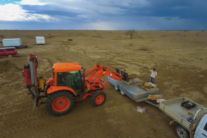 A forklift moves 100 million-year-old dinosaur footprints onto a trailer for relocation in outback Queensland