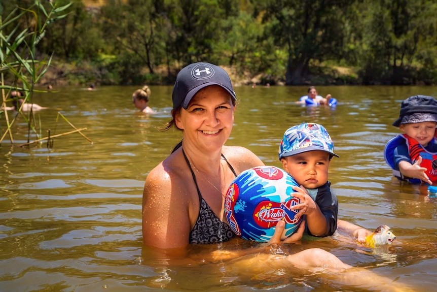 A mother and her child swimming at Casuarina Sands