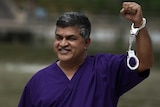 Malaysian cartoonist Zunar poses with handcuffs.