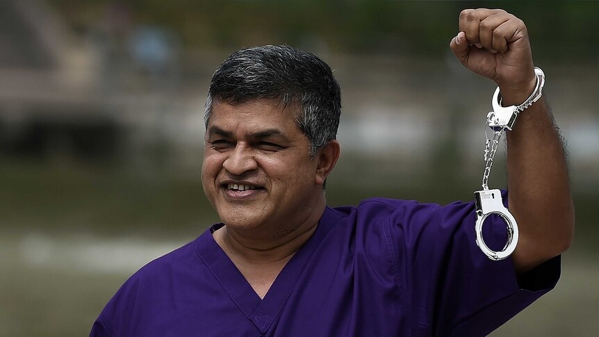 Malaysian cartoonist Zunar poses with handcuffs.
