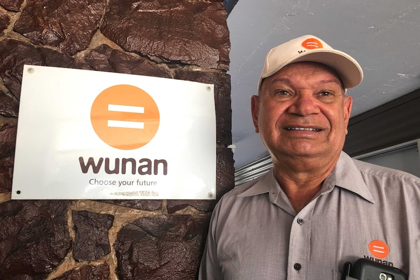 Kununurra Indigenous leader Ian Trust next to a sign for Wunan.