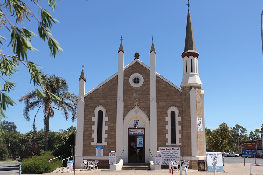 A former stone church which has been turned into a fish and chips restaurant with signage out the front