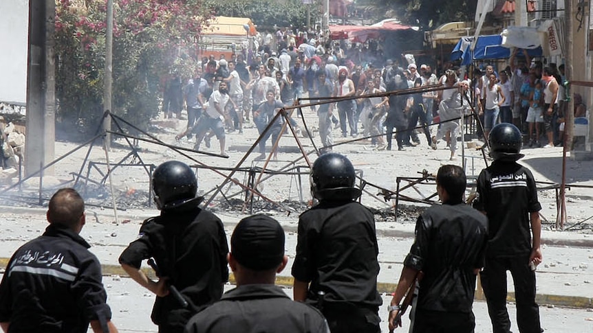 Demonstrators clash with police in Intilaka, outside Tunis.