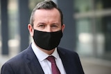 WA Premier Mark McGowan standing outside WA Parliament wearing a black COVID mask. 