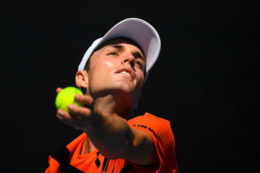 Chris O'Connell looks to the sky as he prepares to serve at the Australian Open.