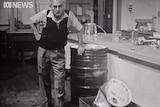 Professor Julius Sumner Miller in a 1964 episode of his show, Why is it so? He stands by a drum with a hand on his hip.