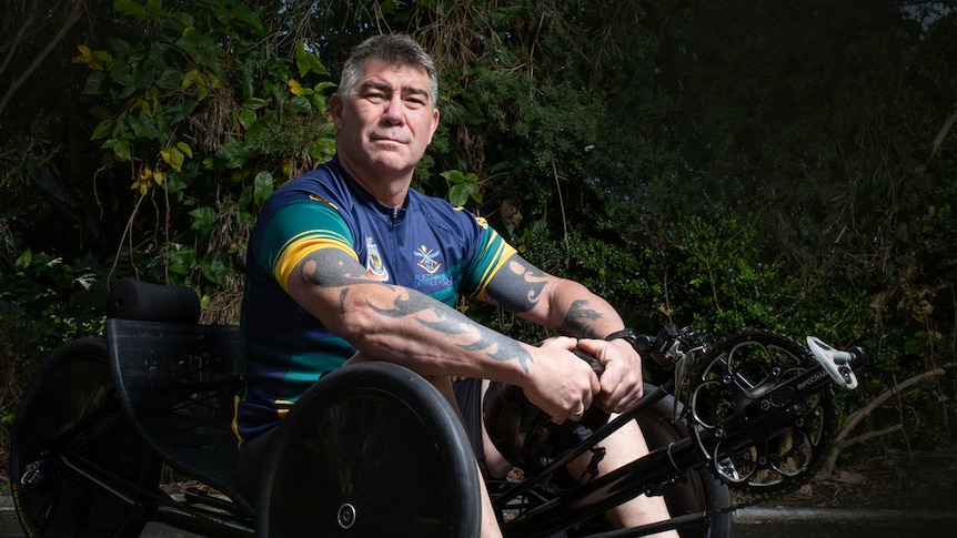 a para athlete sitting in the seat of a recumbent bike