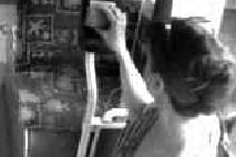 Grainy CCTV black and white image of a woman getting on a bus.
