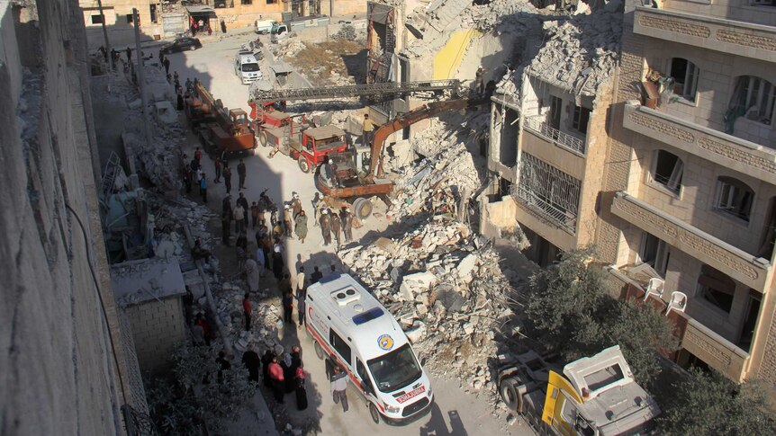 Syrian Civil Defence members search for survivors amid the rubble.