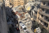 Syrian Civil Defence members search for survivors amid the rubble.