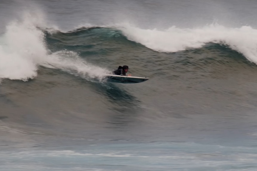 Barney Miller riding a wave 