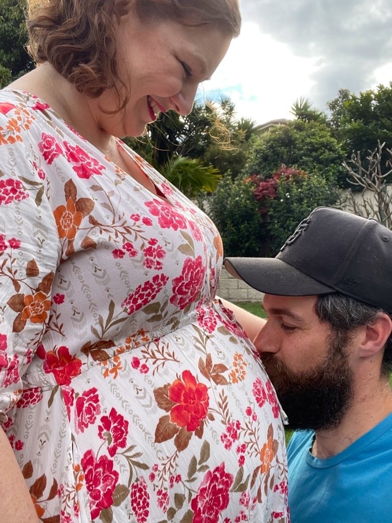 Jenna Guillame and her husband (kissing her pregnant belly).