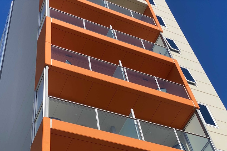 A multi-storey hotel building with orange balconies