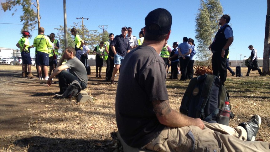 Authorities and people outside Mount Isa airport in north-west Qld, which has been evacuated due to a security breach