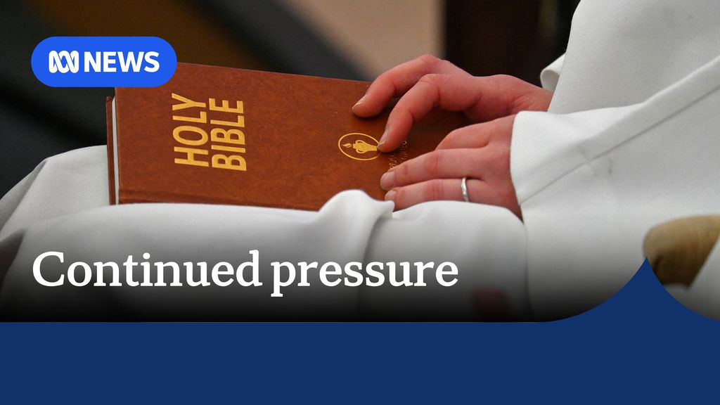 Continued pressure: Clergy holds bible while sitting in Church. 