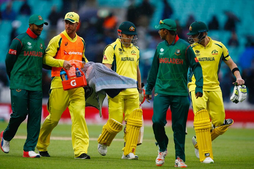 Australia and Bangladesh players walk off The Oval.