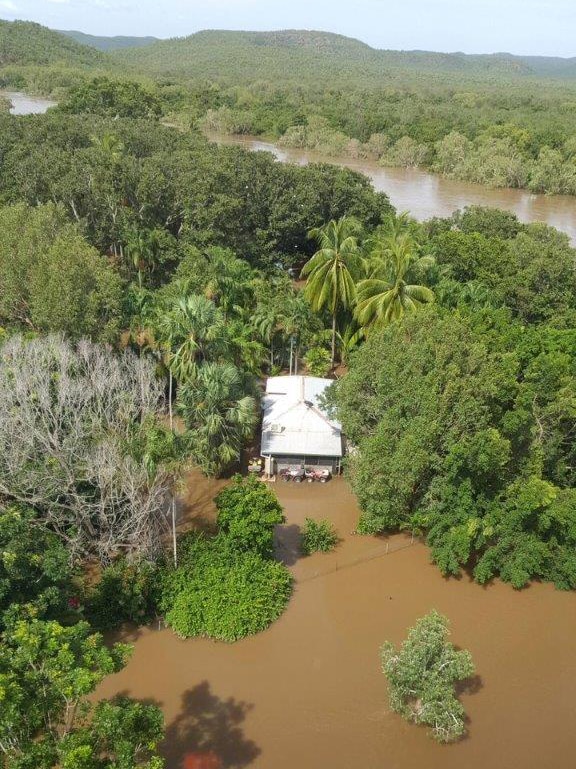 Daly River Mango Farm caravan park seen from the air surrounded by floodwaters.