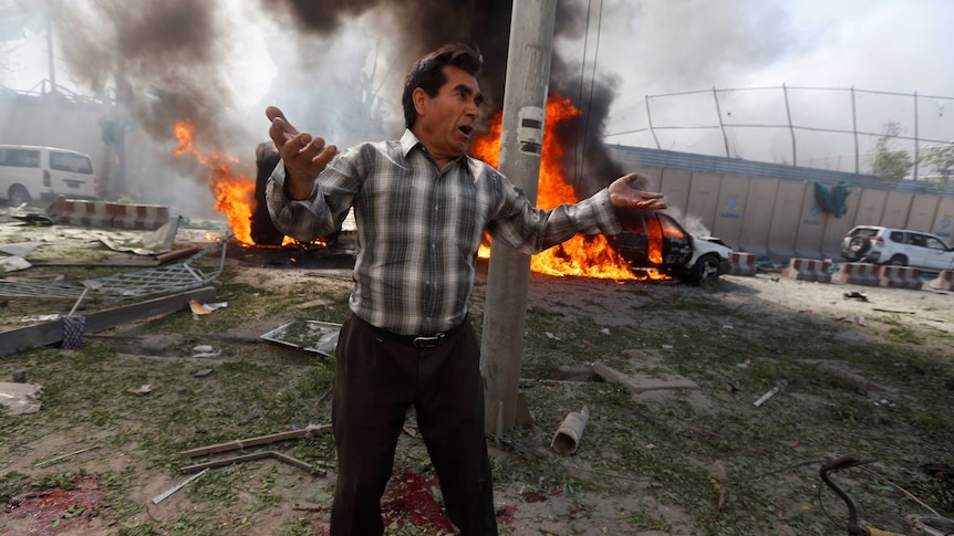 An Afghan man reacts at the site of a blast in Kabul, Afghanistan May 31, 2017.