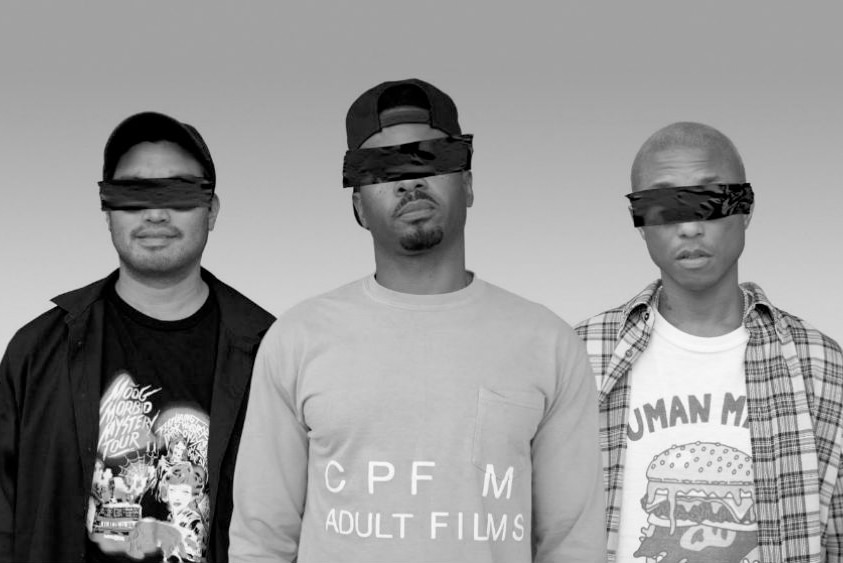 A black and white 2017 press shot of N.E.R.D: Chad Hugo, and Shay Hayley, Pharrell Williams