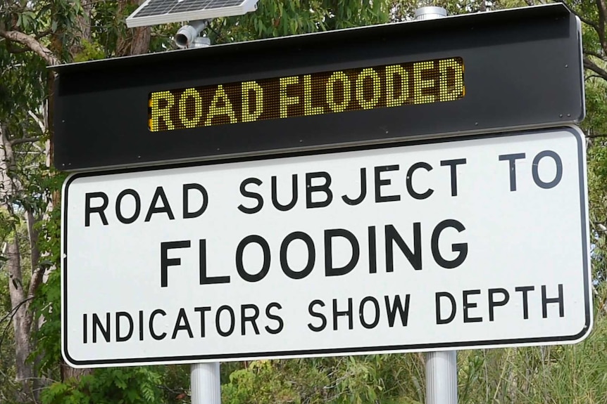 Solar-powered 'Road subject to flooding' sign made from recycled lithium batteries and bright, flashing LED signs.