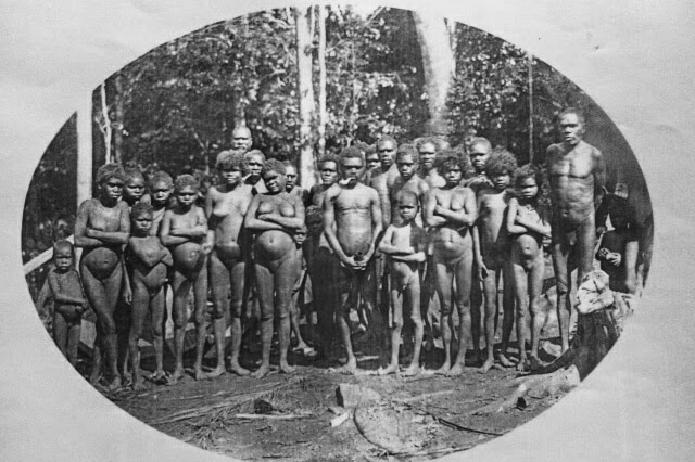 Ngadjon-Jii people of the Atherton Tablelands stand in a line in the nude.
