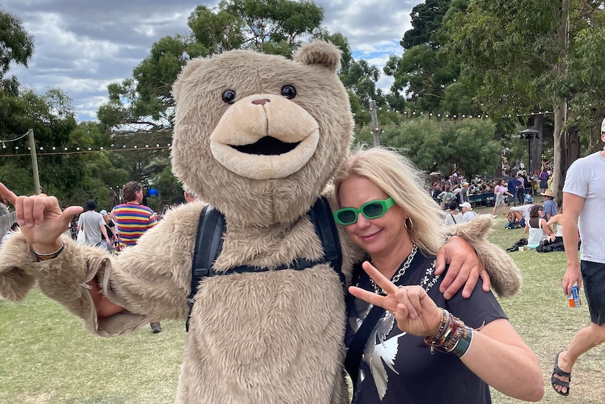 A man in a bear costume poses for a photo with Double J host Karen Leng at Golden Plains festival 2023