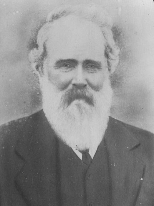 An old man with a white beard in a historic black and white portrait photograph.