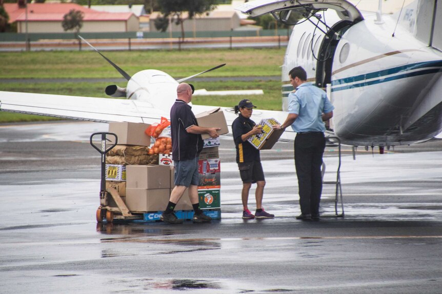 A light plane in Kalgoorlie being loaded with food to be flown to Tjuntjuntjara.