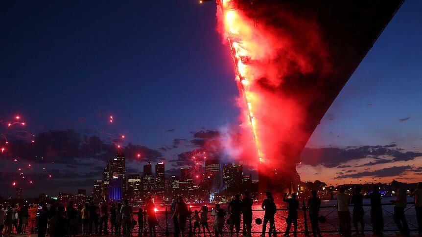 People watch fireworks around Sydney Harbour during New Years Eve celebrations.