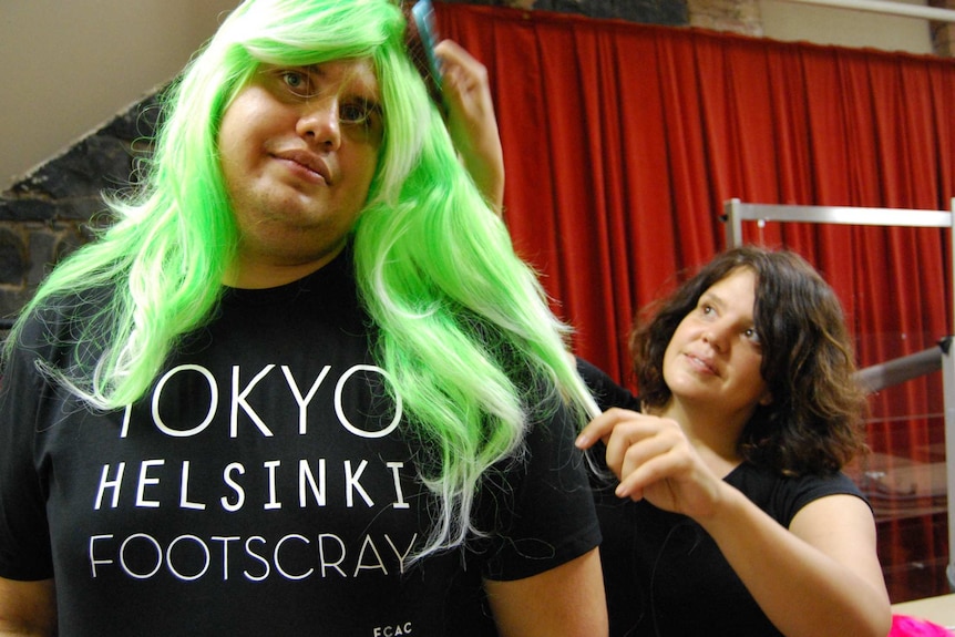 Genevieve Greeves brushes brother Yagan Satour's drag wig.