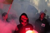 Pension protest: rail workers hold flares in Paris as part of nationwide rallies against pension reform.