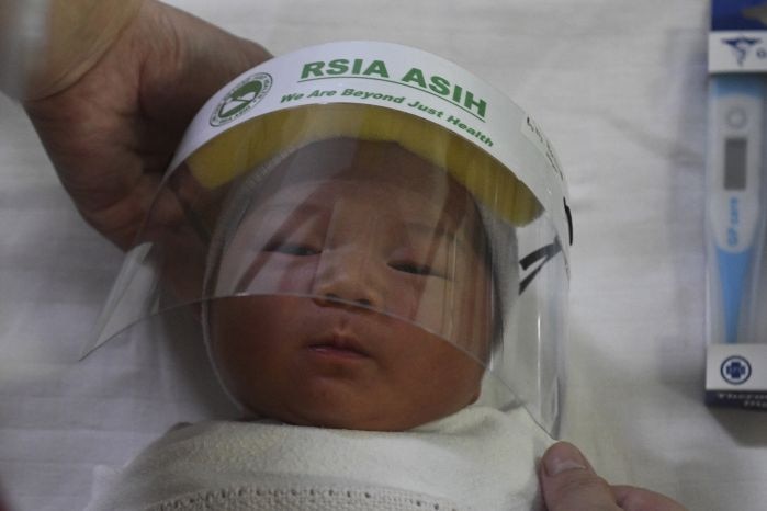 A new baby born wearing face shields
