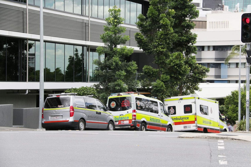 Ambulances parked outside in street of Hotel Grand Chancellor at Spring Hill in inner-city Brisbane.