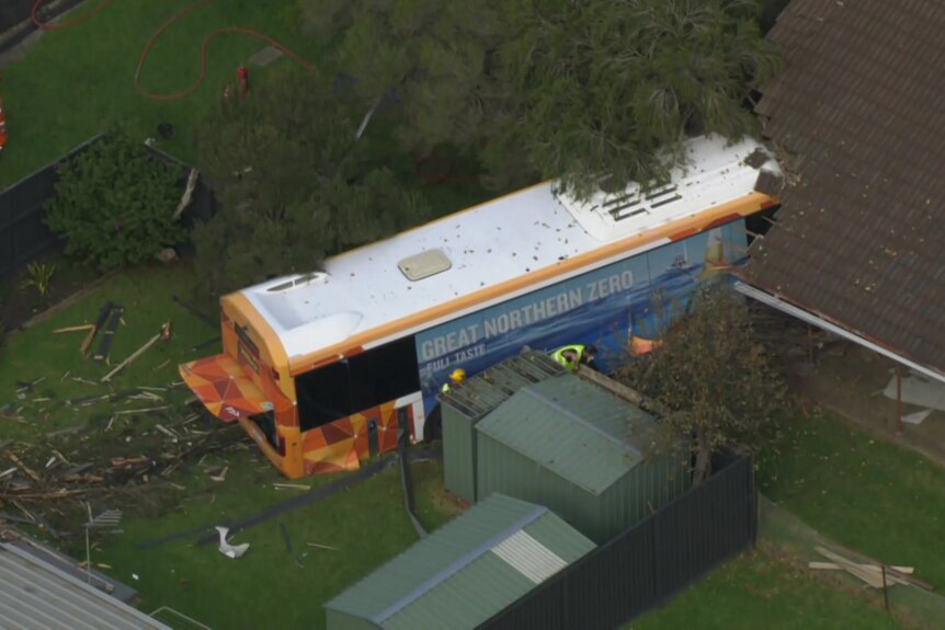 A bus that has crashed into a suburban home