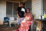 15-year-old Taylen stands next to his mother Cherylene, who uses a wheelchair, at a home in Katherine. 