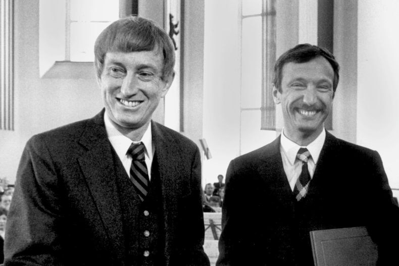 Peter Doherty and Rolf Zinkernagel as younger men in suits and smiling