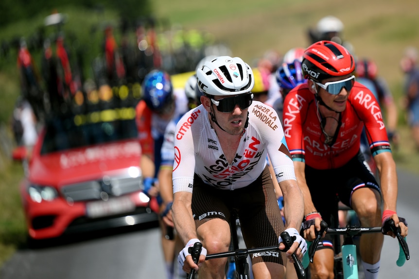 Ben O'Connor strains while riding during the Tour de France