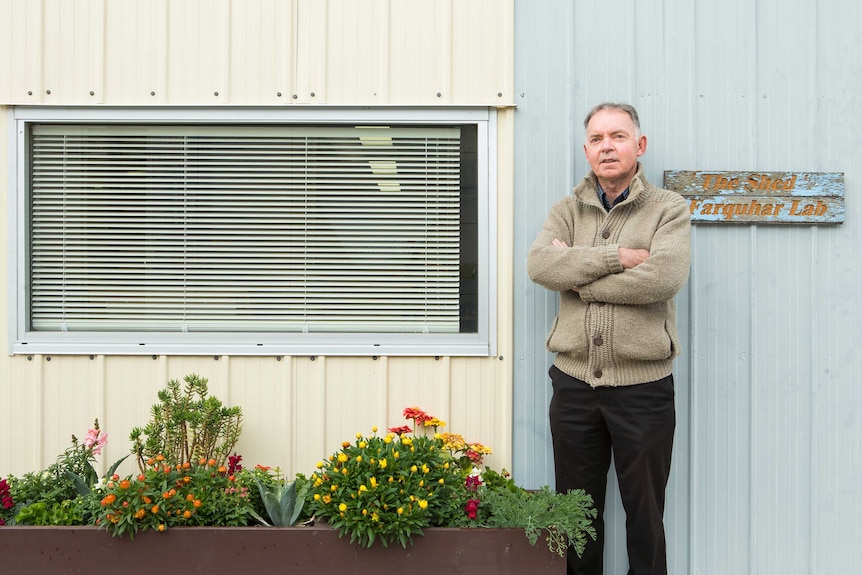 Graham Farquhar beside a garden bed at the lab.