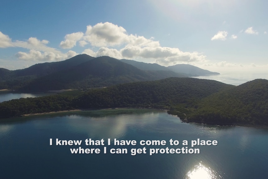 Still from Vernon Ah Kee's The Island video featuring a beautiful island landscape with stark white words