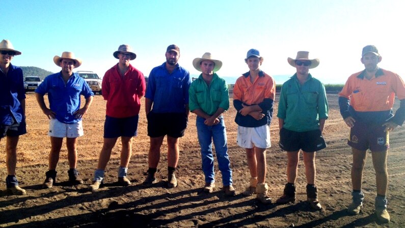 Young farmers stand in a line on the Liverpool Plains black soil.